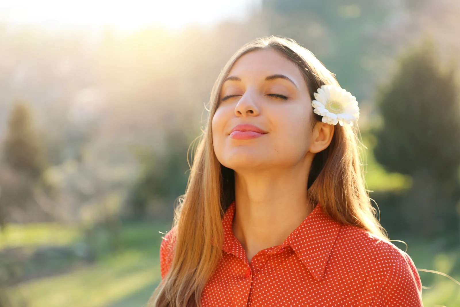 A woman looking calm and healthy in warm natural light, representing whole-body wellness and regenerative aesthetics at Pure Body Health in South Tempe, AZ