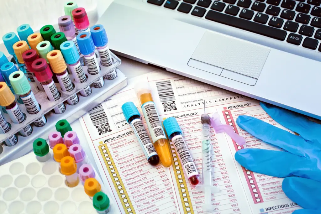 Color-coded blood sample tubes and lab analysis reports, representing the root-cause lab testing behind naturopathic weight loss at a South Tempe, AZ clinic.