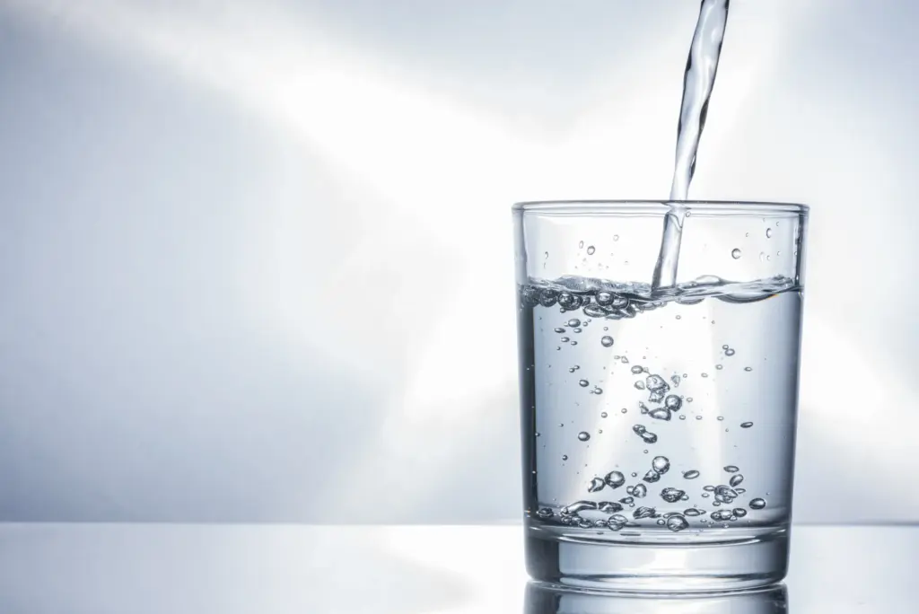 Water being poured into a clear glass, illustrating the steady hydration that eases side effects on semaglutide, guidance from South Tempe, AZ naturopathic physicians.