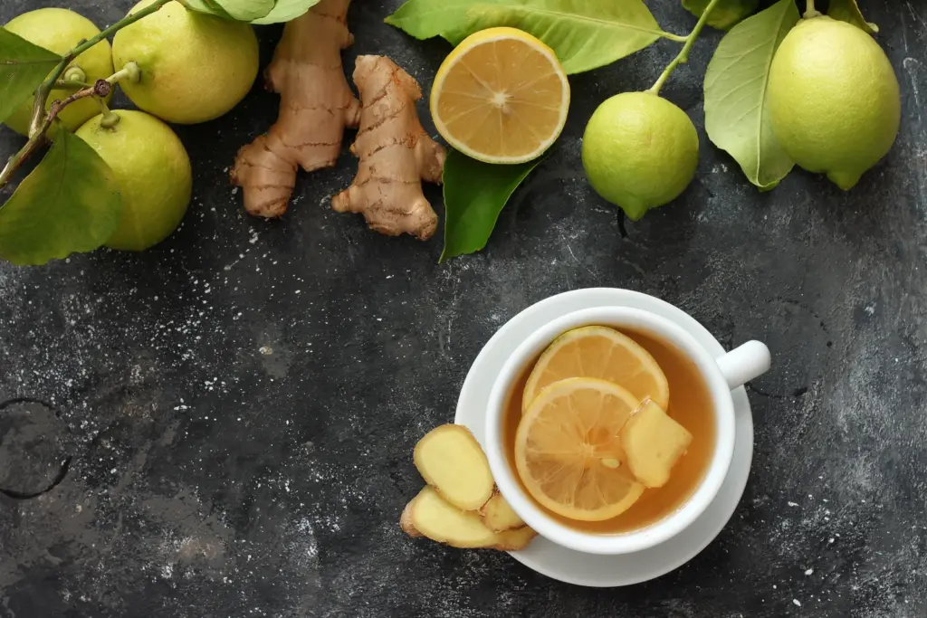 A cup of ginger tea with lemon and fresh ginger root, a gentle remedy for the nausea that semaglutide can cause, from a South Tempe, AZ clinic.