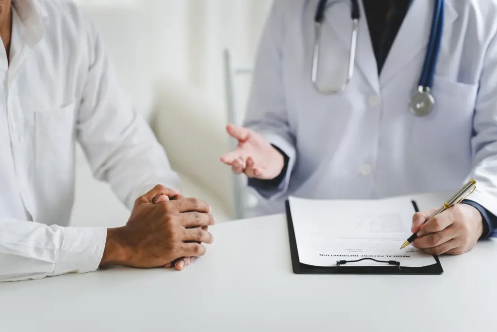 A provider reviews a patient intake form across the desk while comparing semaglutide and tirzepatide in South Tempe, AZ.